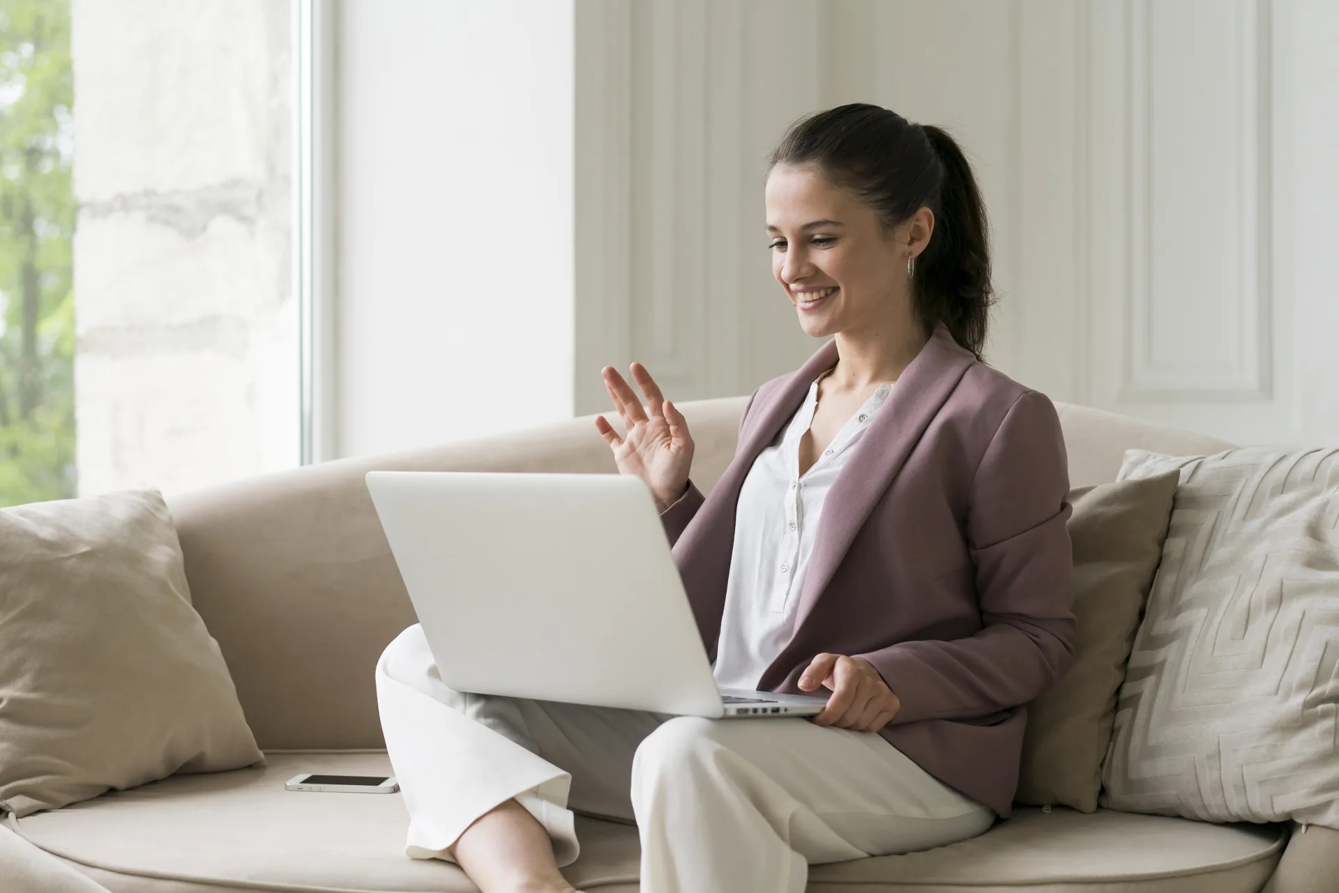 Woman connecting through a video call at home